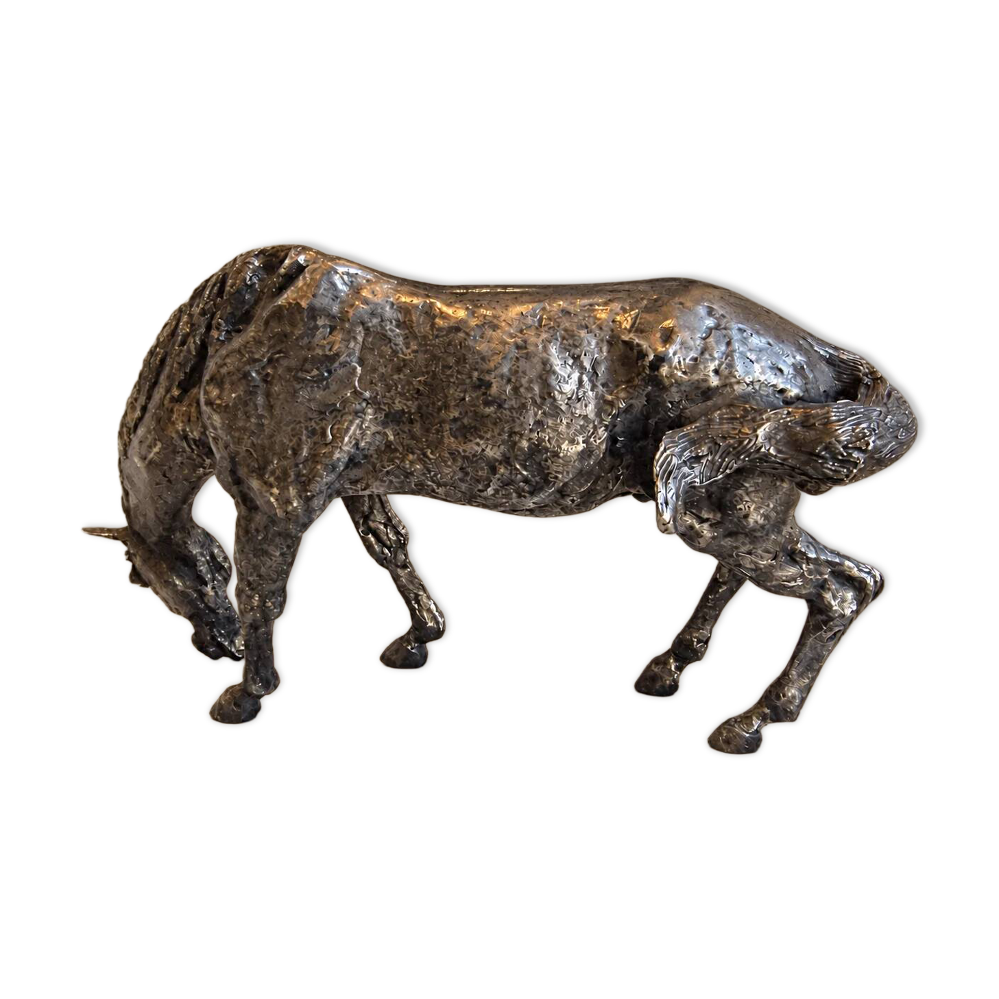 Sculpture of a grazing horse with a silver finish.