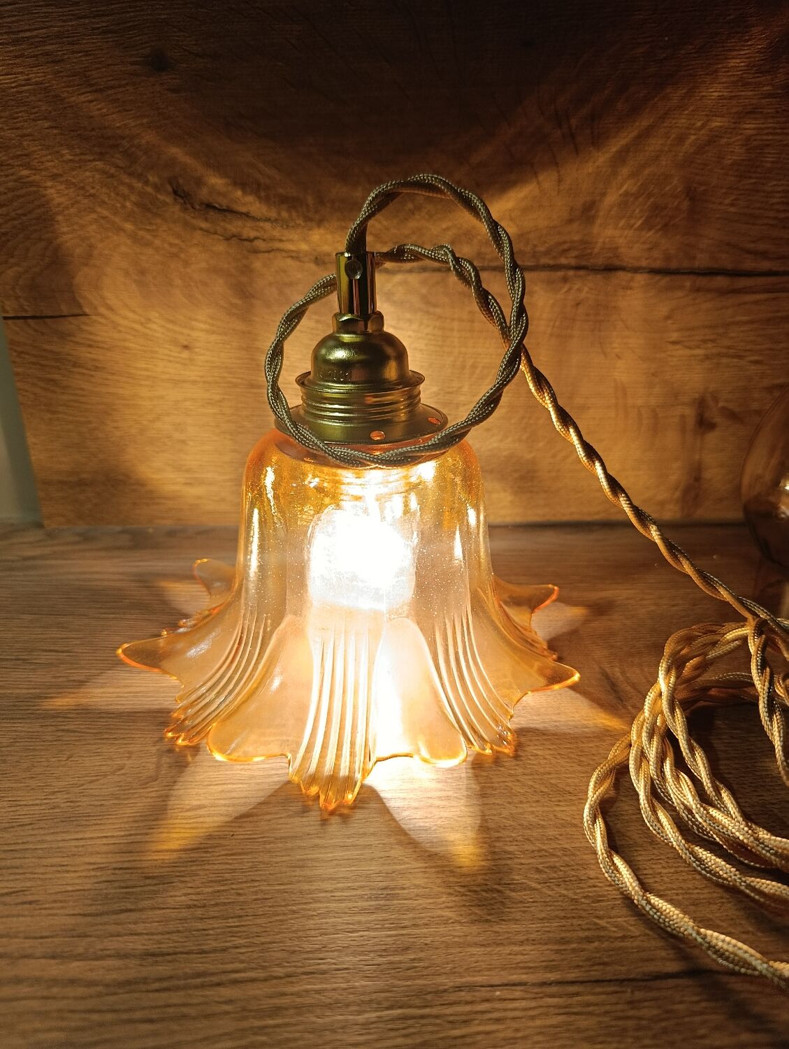 Amber tulip glass portable lamp, golden braided cord.