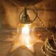 Amber tulip glass portable lamp, golden braided cord.