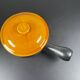 Black and yellow fondue pot