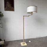 Floor lamp with articulated arm in brass-plated metal