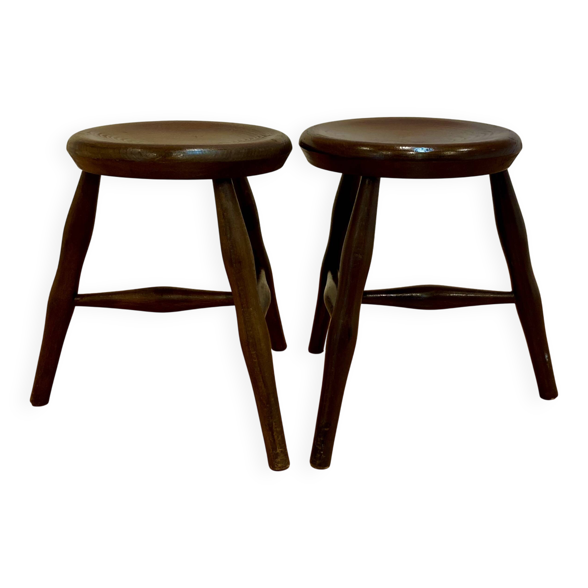 A pair of tripod stools from the period.