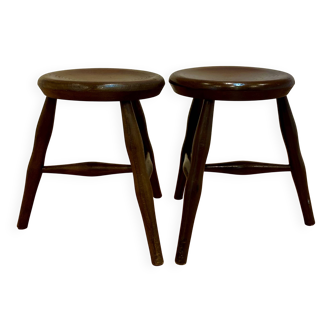 A pair of tripod stools from the period.