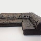 Vintage corner sofa composed of 3 modules in black leather with integrated bed.