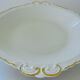 Hollow dish in white porcelain, golden lip.