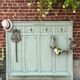 Cloakroom with sage green wall coats
