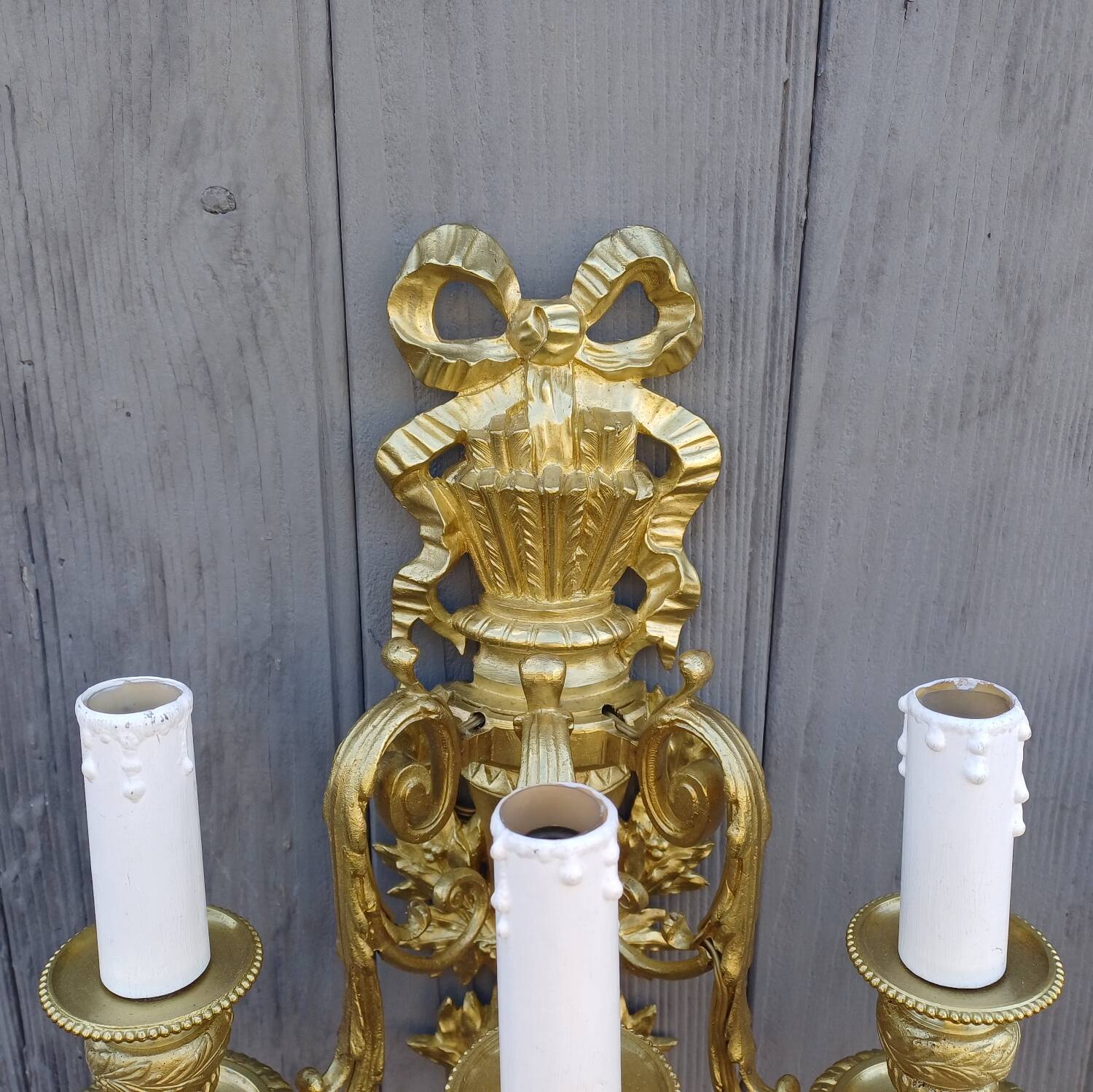 Pair of antique bronze wall sconces from the Napoleonic III era in the Louis XVI style.