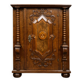 Ornamental piece of solid wood furniture, richly carved, dating from the 17th century.