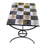 Vintage coffee table with black wrought iron and white tiles.