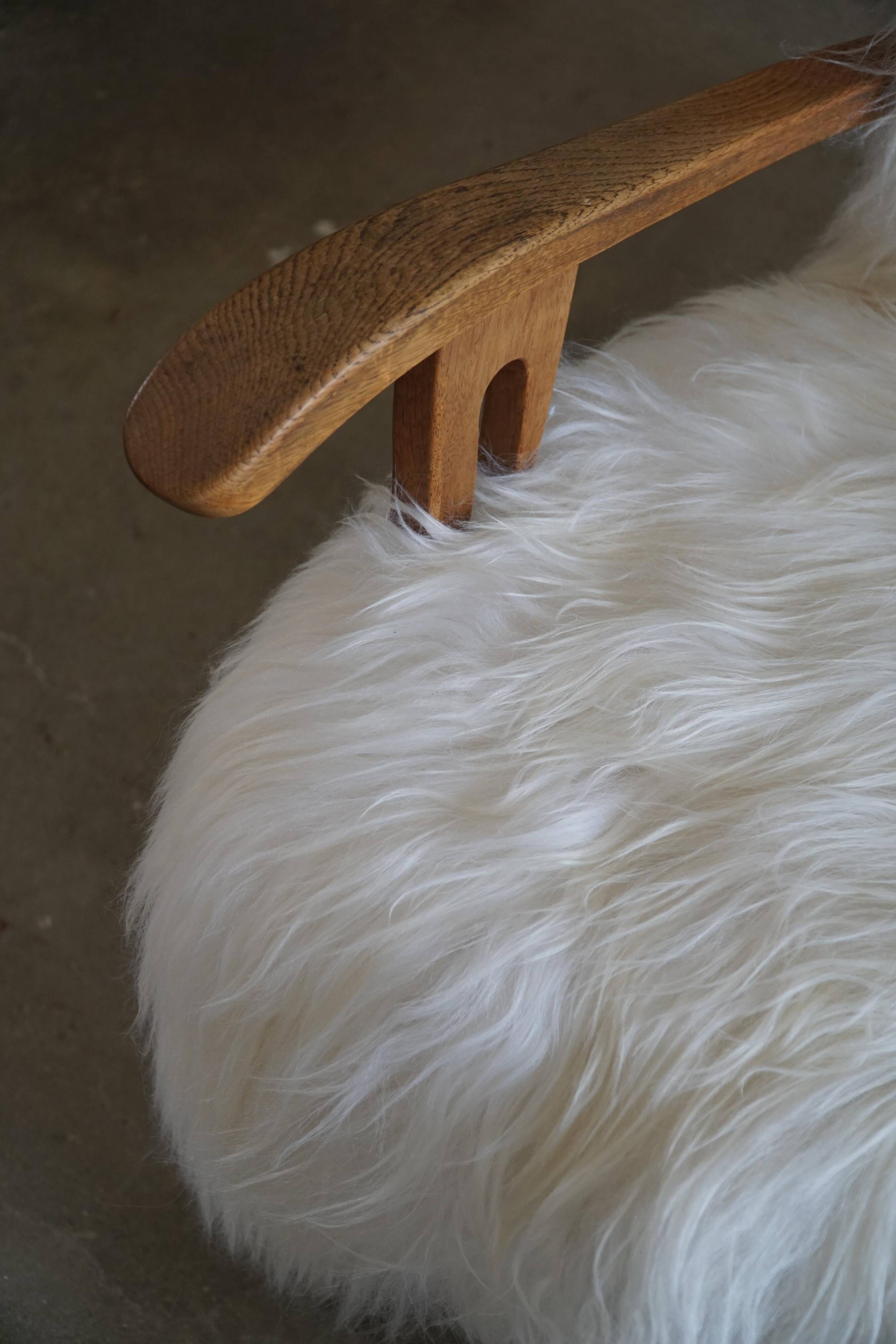 Pair of Scandinavian armchairs in oak and long-haired Icelandic sheepskin by Henning Kjærnulf, 1950.