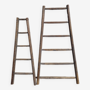 Two weathered wooden ladders H.135 cm