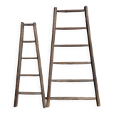 Two weathered wooden ladders H.135 cm