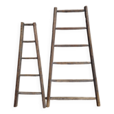 Two weathered wooden ladders H.135 cm