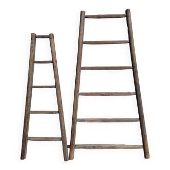 Two weathered wooden ladders H.135 cm