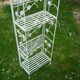 Folding white wrought iron shelf