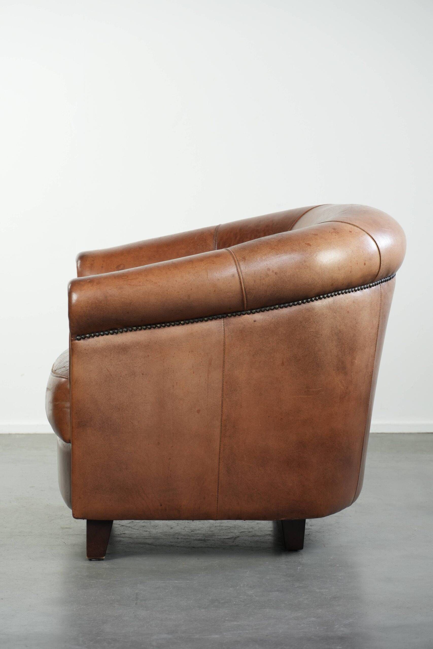 Vintage sheepskin club armchair in English style with deep colours