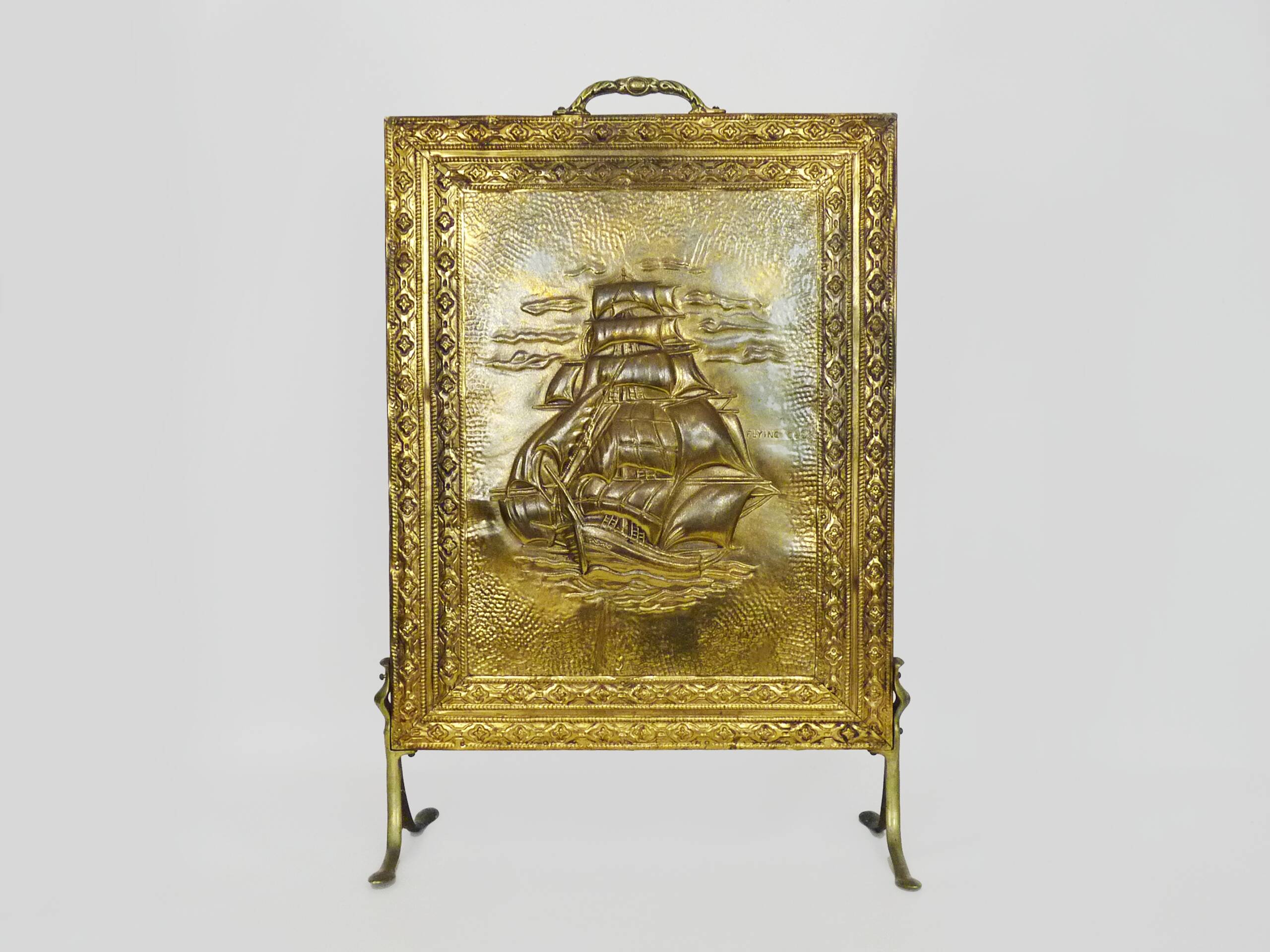 Fireplace screen in repoussé brass with a sailing boat. 1960s.