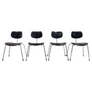 Set of four Egon Eiermann model SE 68 chairs in black lacquered plywood and steel.