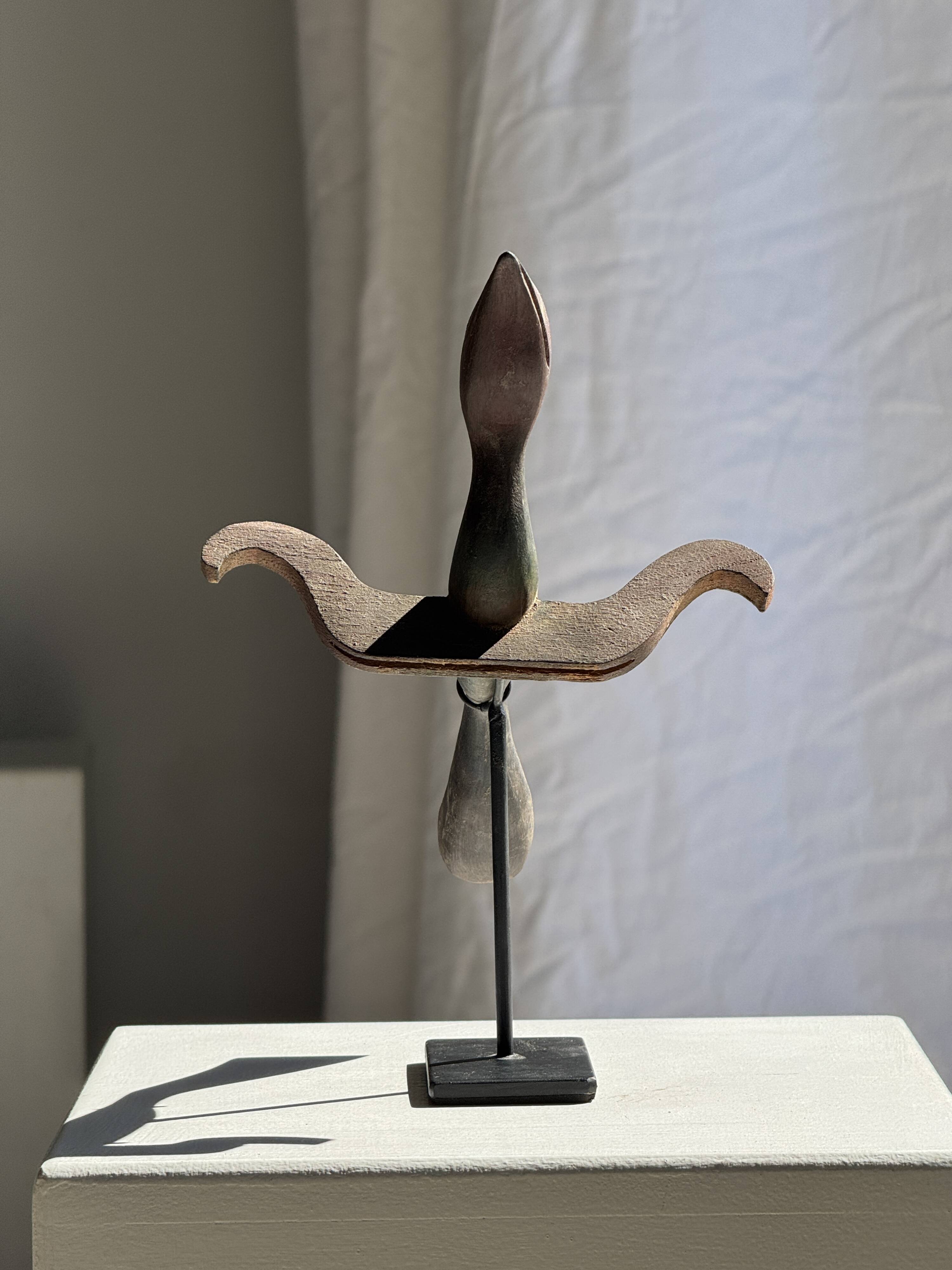 Traditional Indonesian decorative wooden bird on a base, crest model.