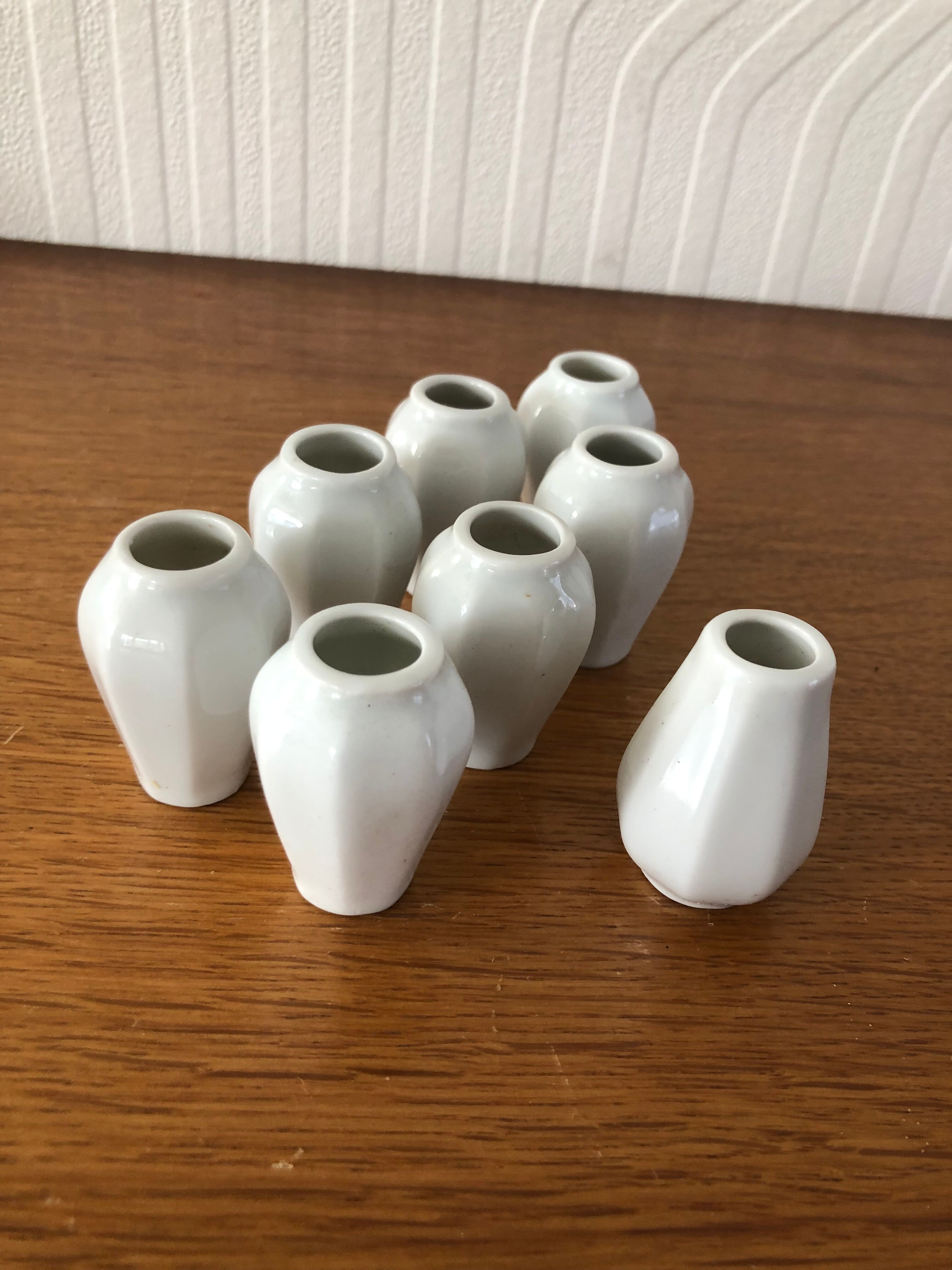 8 miniature vases in white earthenware