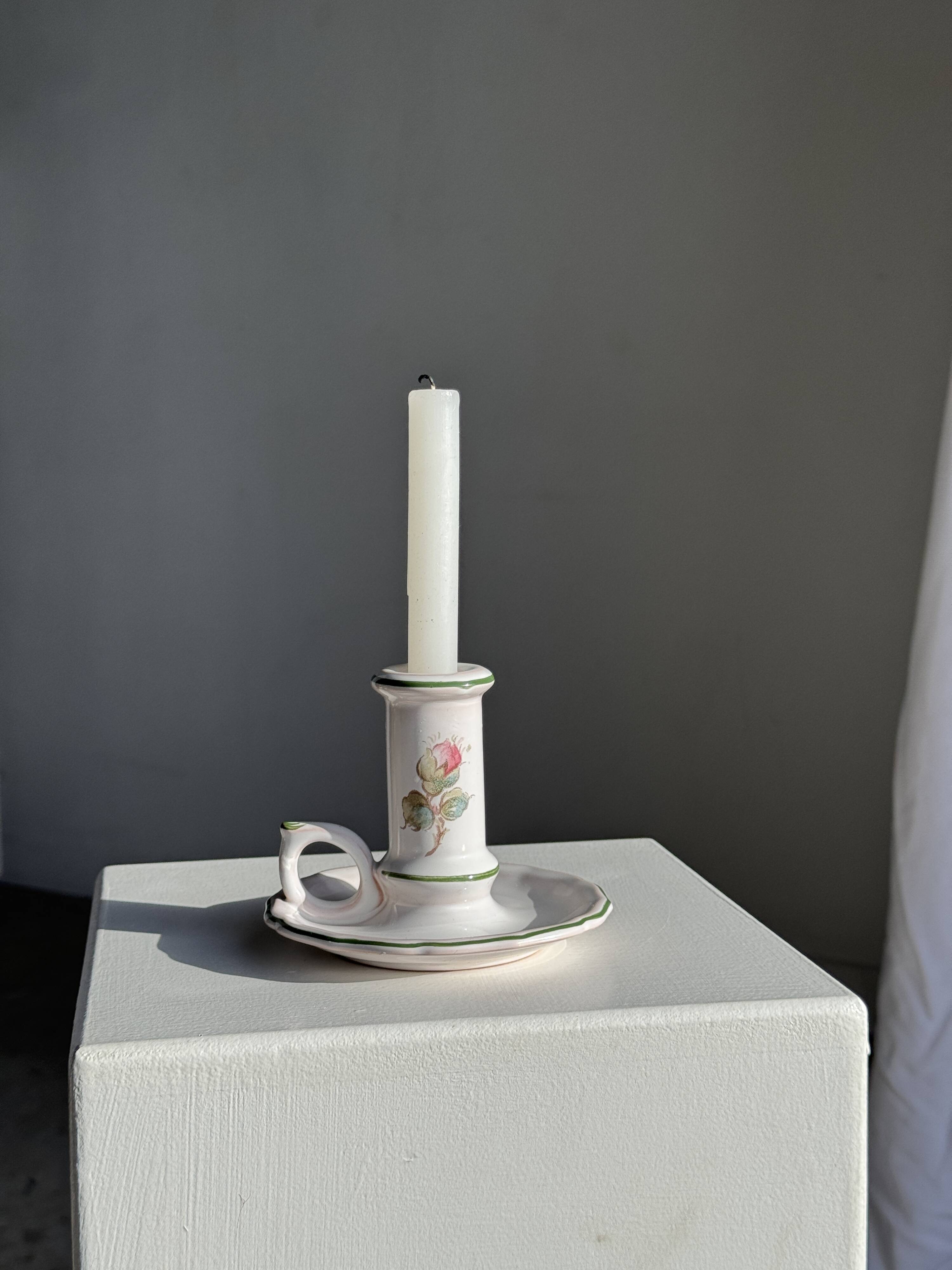 Small vintage hand-held candlestick in earthenware with green trim and floral decoration H10.5