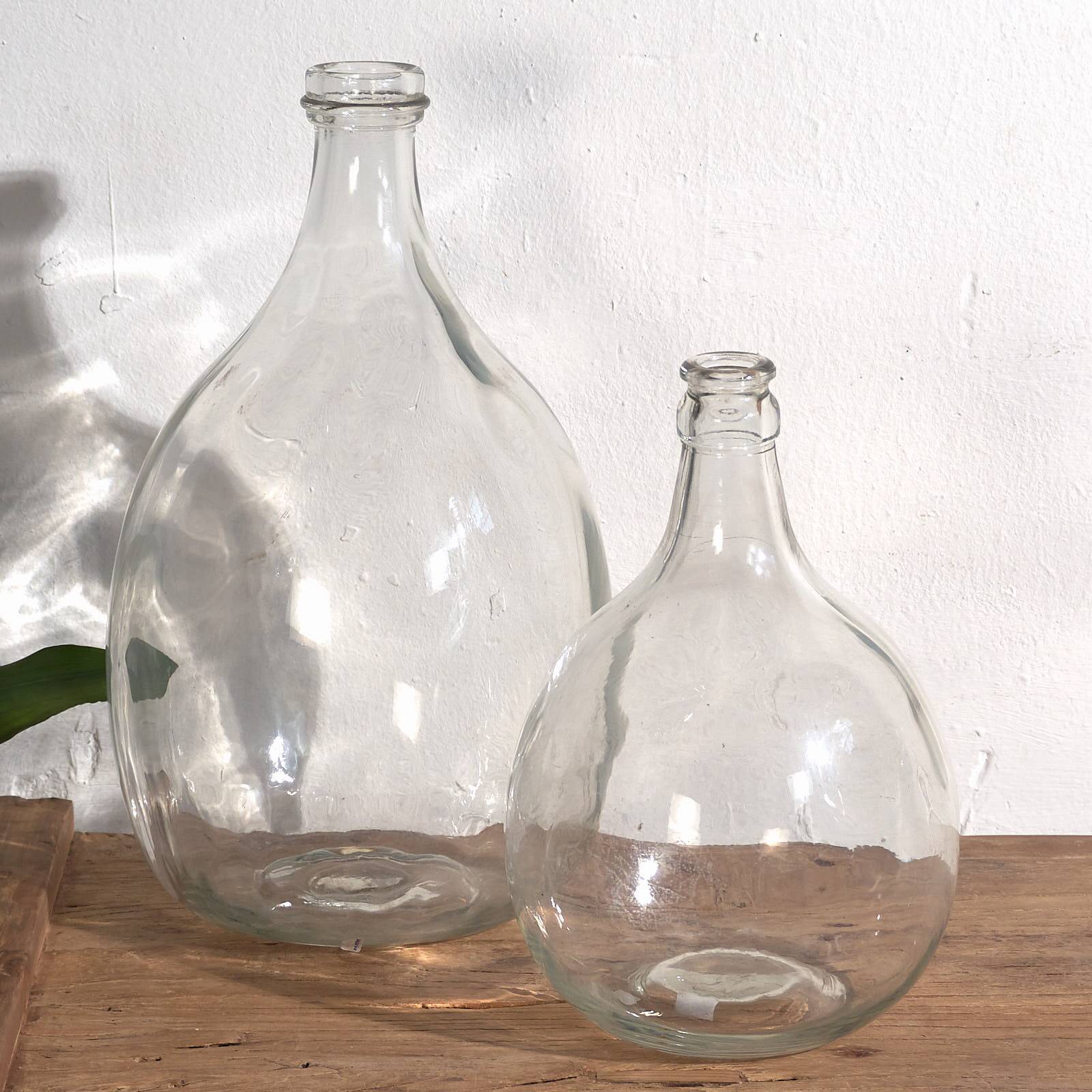 Antique glass demijohns (c.1920). Set of 2 pieces
