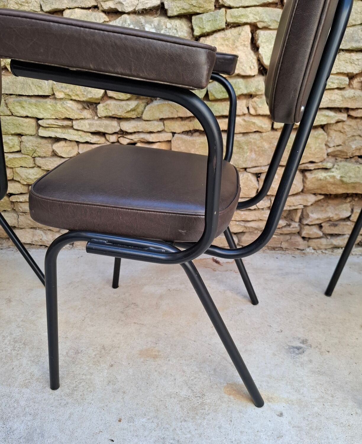 Brown faux leather armchairs