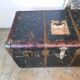 Old and large travel trunk, brass-plated corners