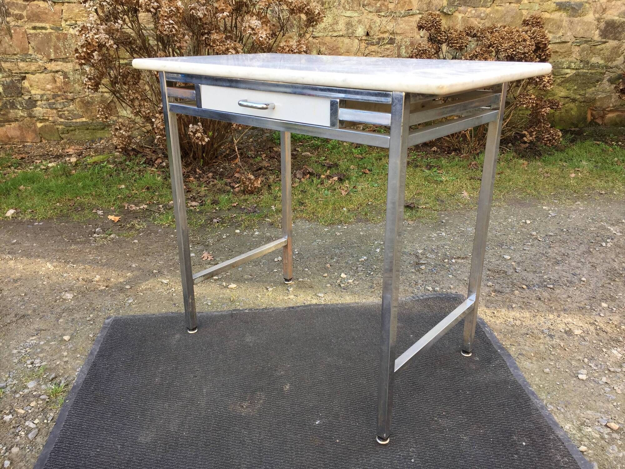 Vintage table with square chrome tubular metal base and marble top with 1 drawer.