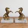 Pair of vintage bookends with rearing horses in gilded metal on marble bases.