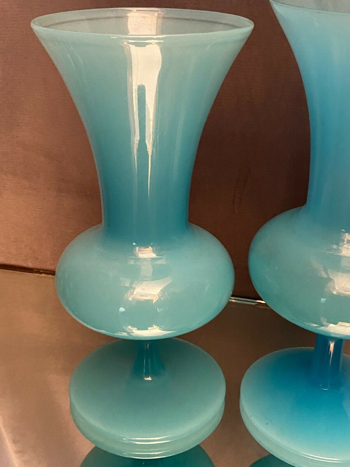 Two vases on a pedestal in blue opaline