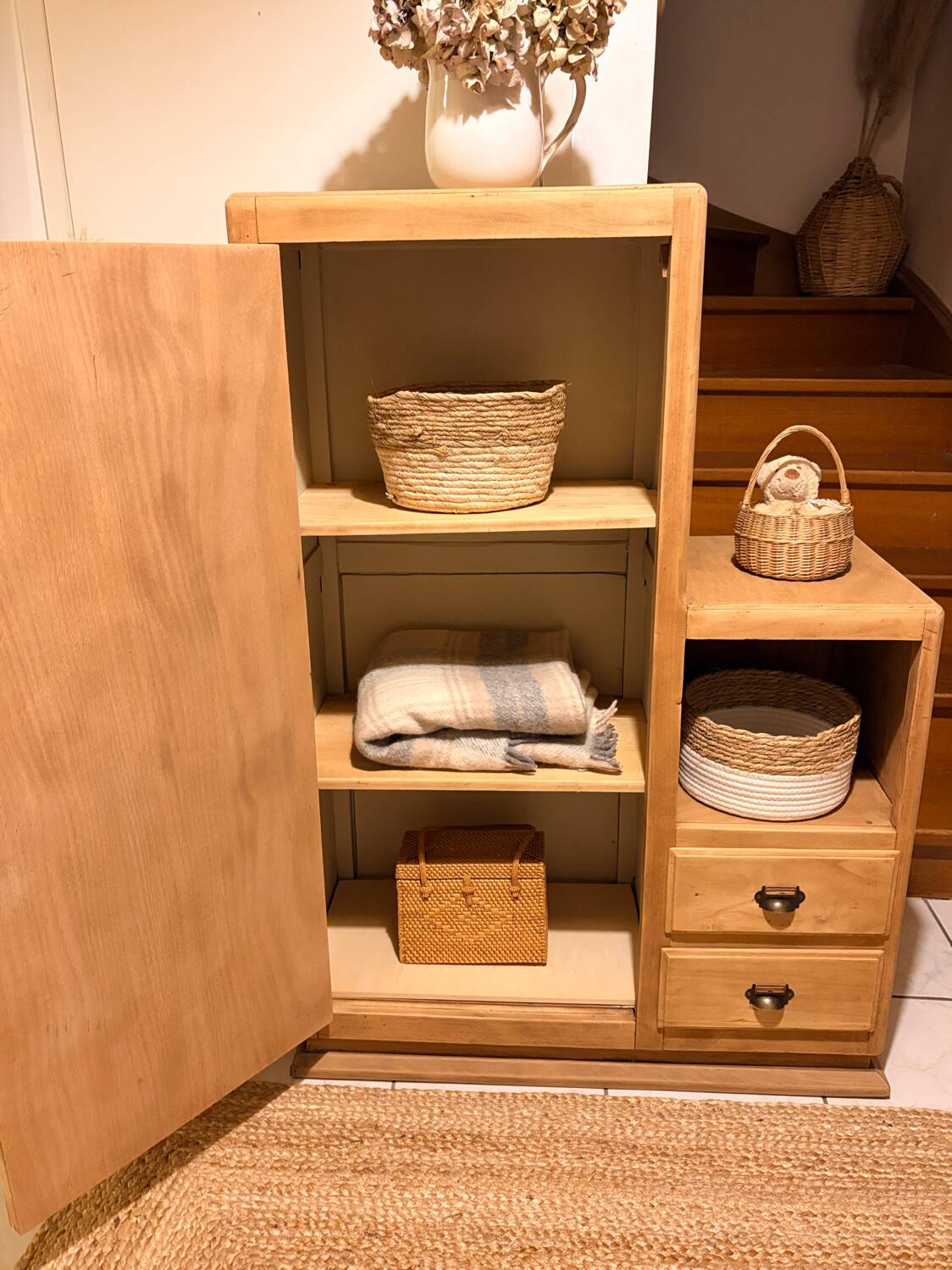 Asymmetrical cabinet made of raw wood