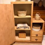 Asymmetrical cabinet made of raw wood