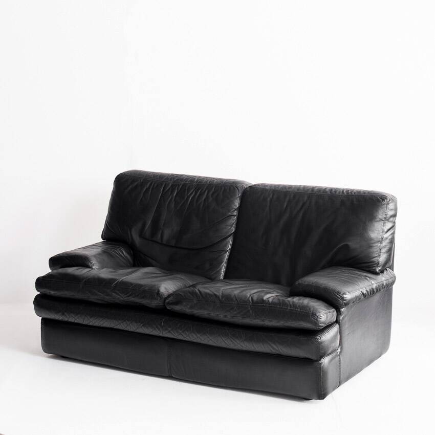 Black leather two-seater sofa. Roche Bobois edition. France, 1980s.