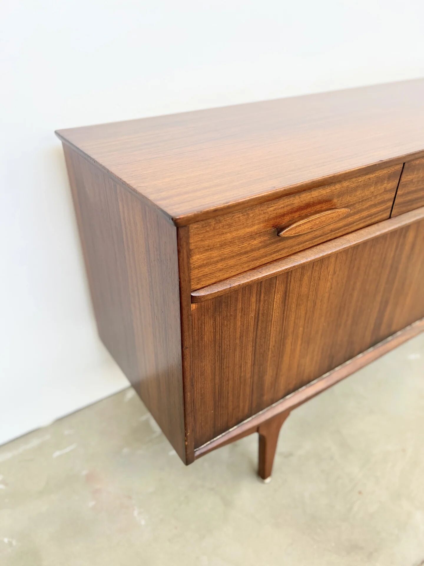 Teak Jentique sideboard — 1 door, 2 drawers & drop-down bar, England 1950s-60s