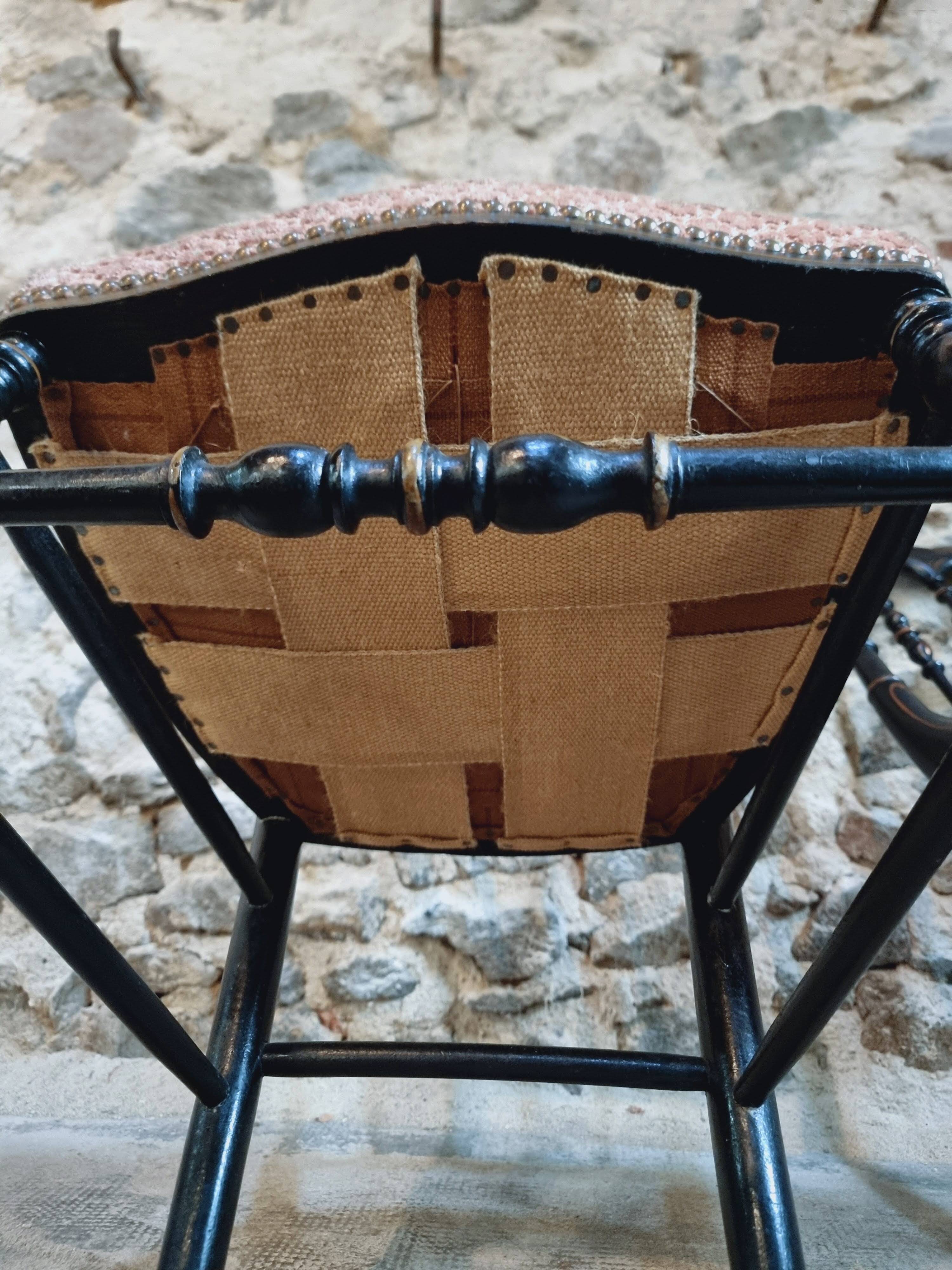Pair of antique Napoleon III chairs in blackened wood and fabric.