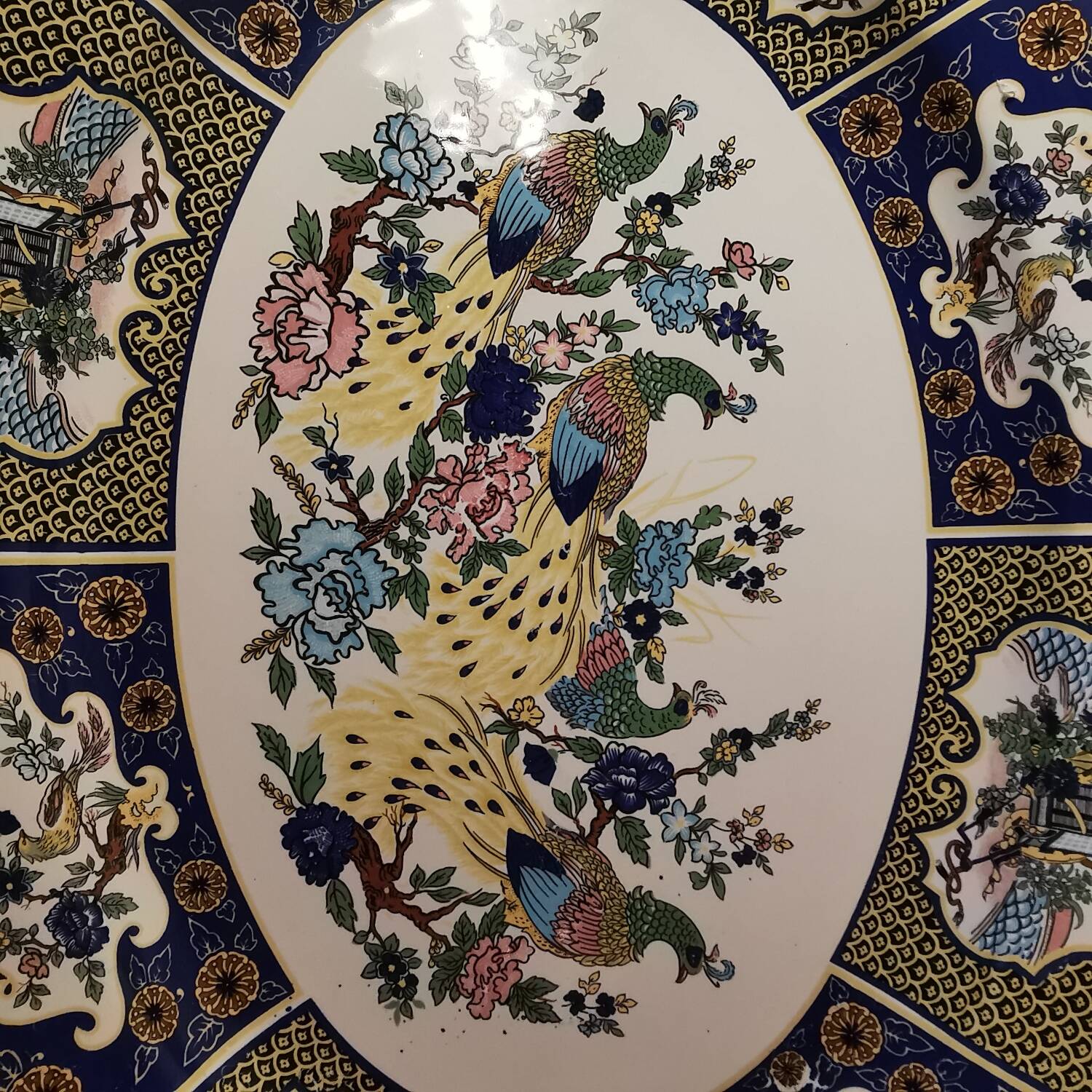 Ceramic dish decorated with peacock folk art Asian motif