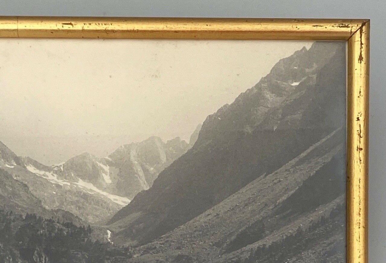 Photo in black and white mountain lake in golden frame
