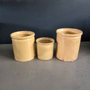 Trio of ancient pots in yellow glazed terracotta.