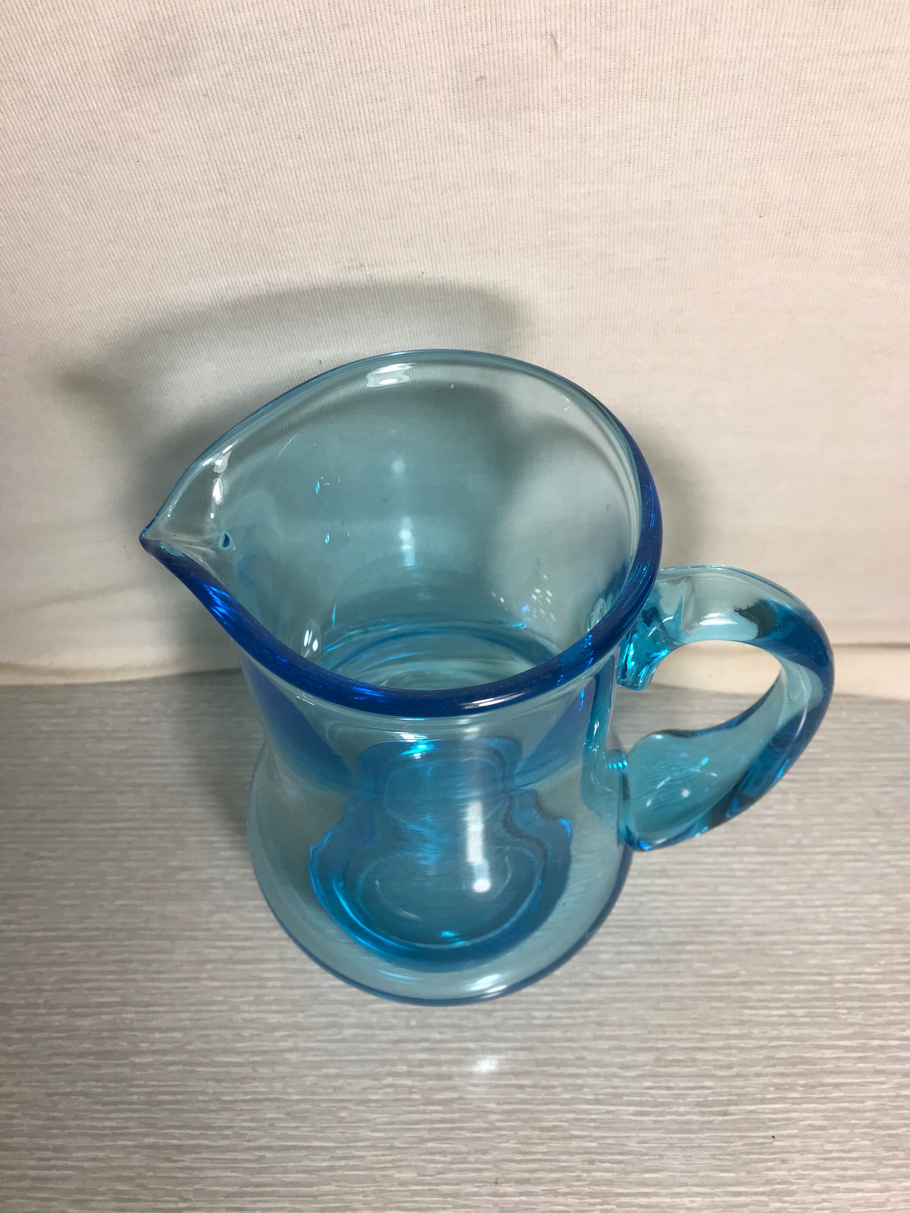 Old blue blown glass pitcher with vintage handle