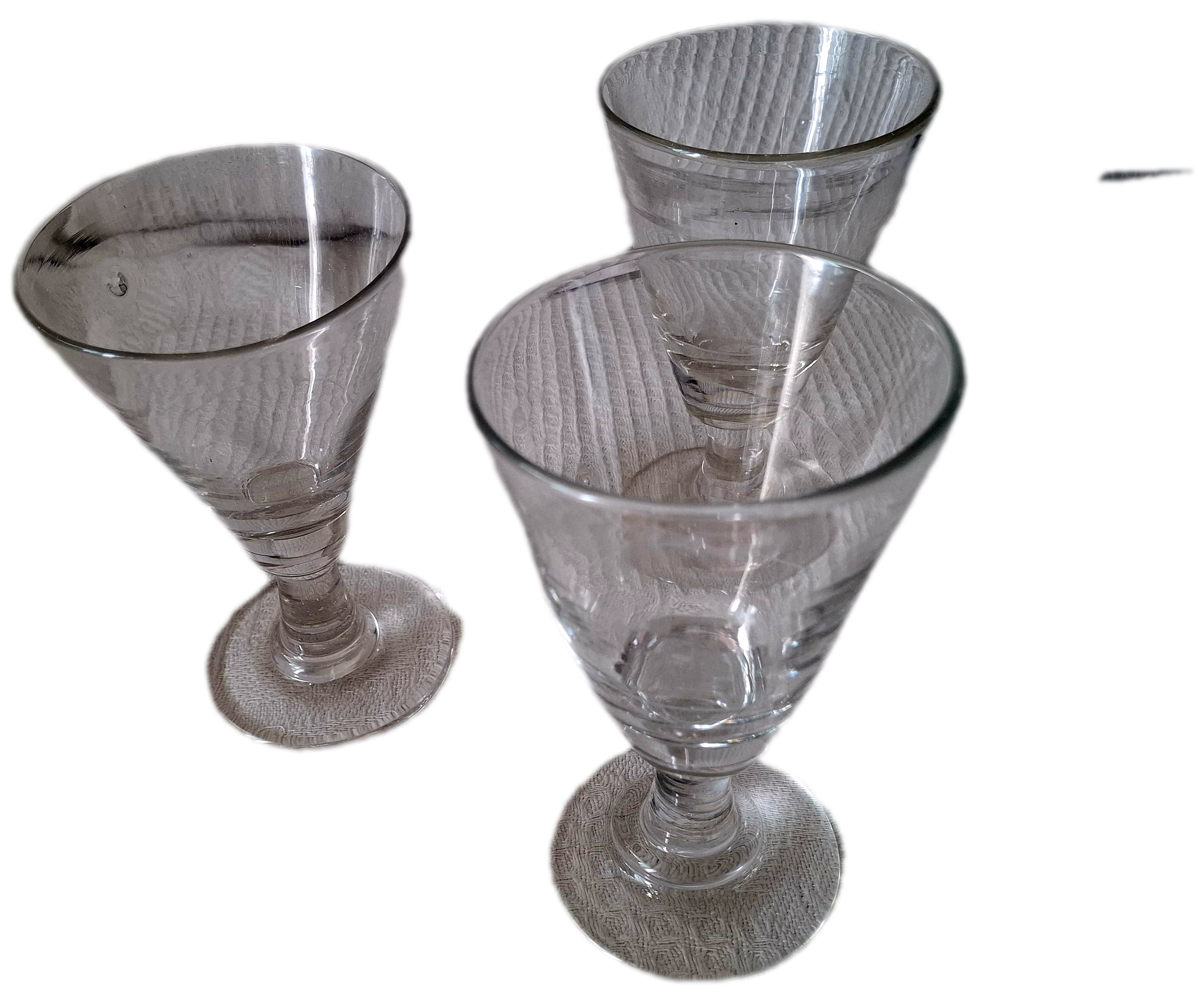Three conical measuring glasses