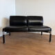 Vintage 2-seater banquette in black faux leather – 1980s
