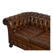 Restored vintage leather Chesterfield canapé in Thomas Chippendale style.
