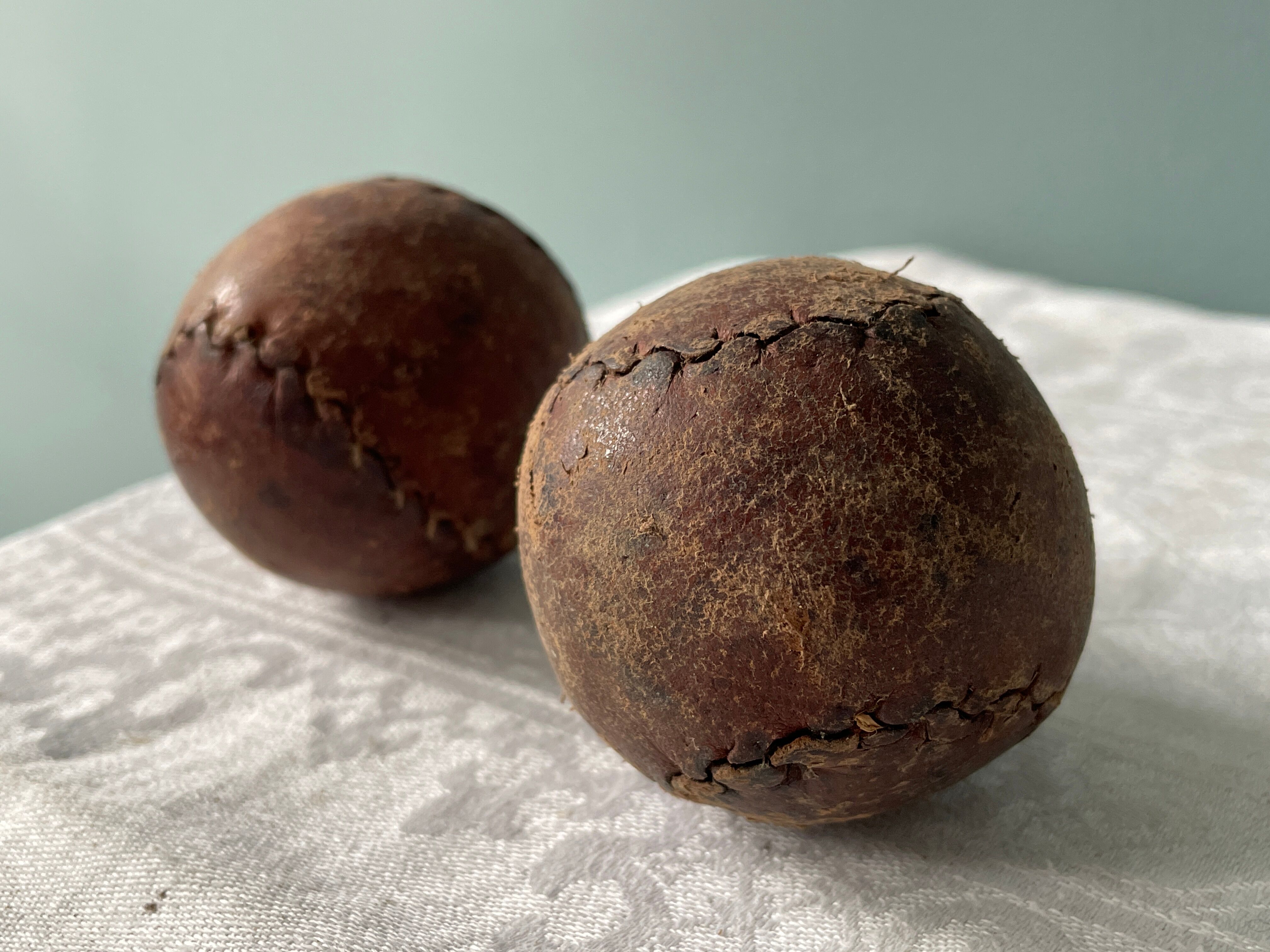 Two old nineteenth century leather golf balls