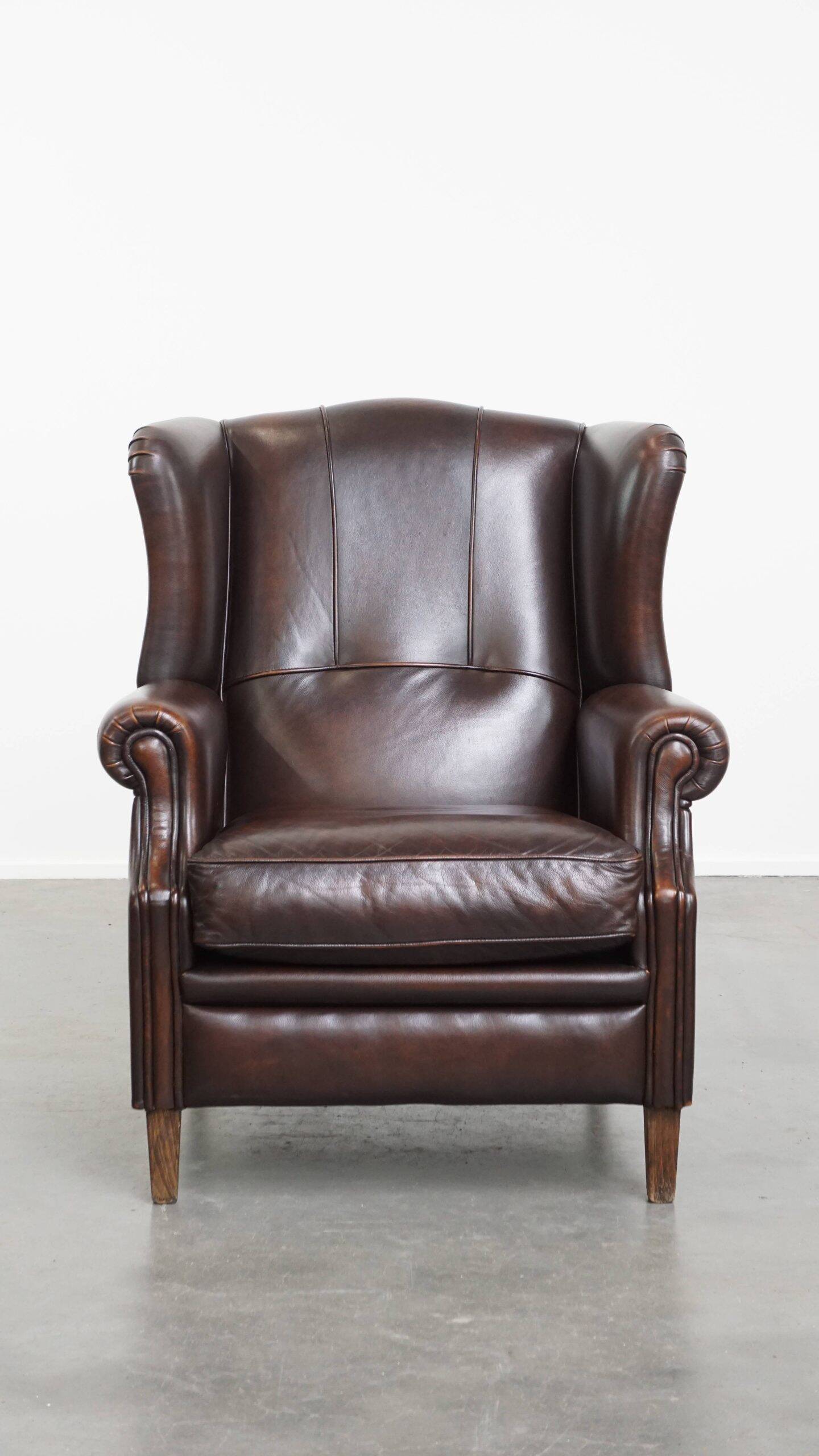 Very beautiful wing chair made of cowhide leather in English style