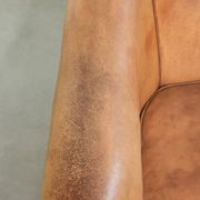 Comfortable sheepskin club armchair in a cognac colour