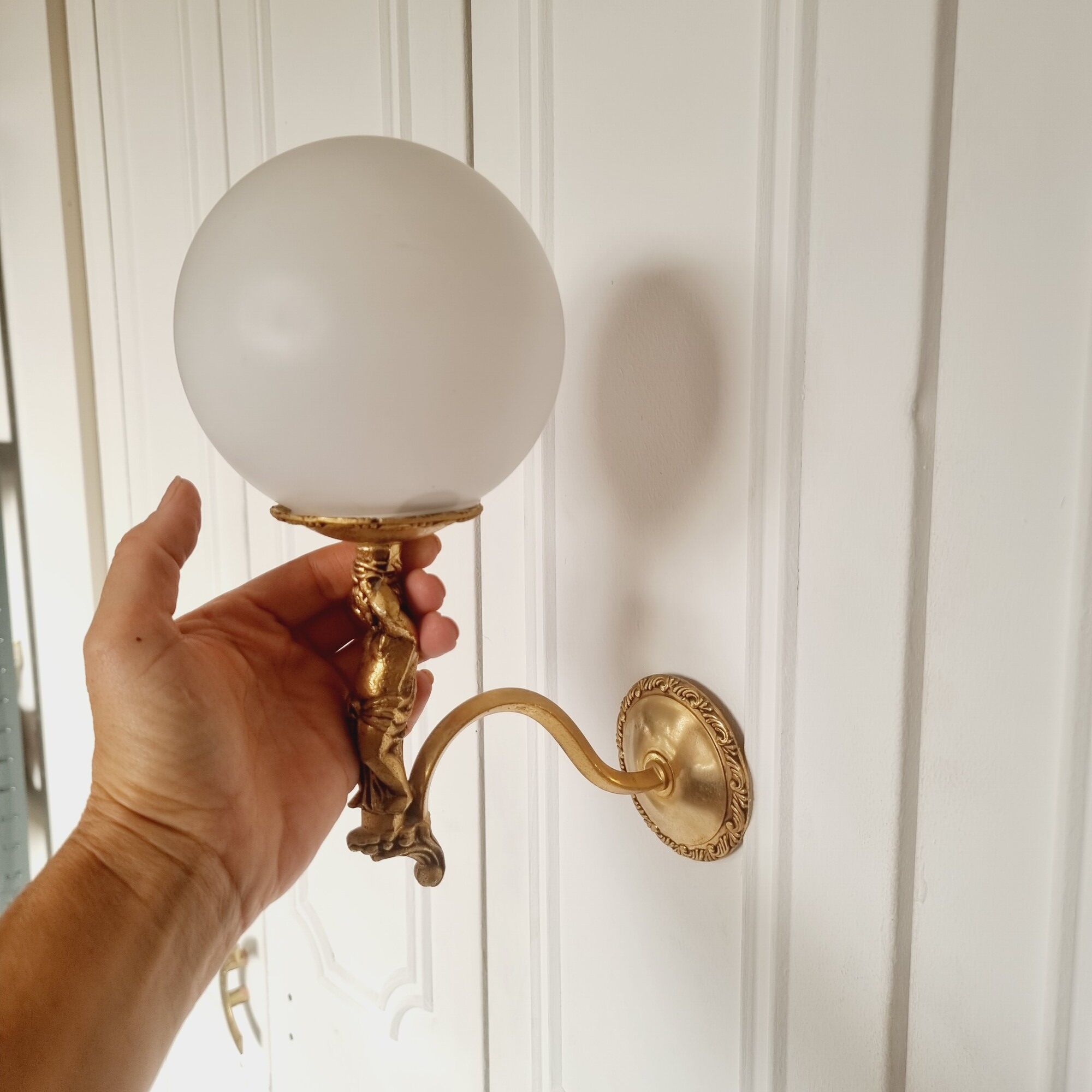 2 classic golden cherub wall lights and globe lampshades in perfect condition.