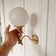 2 classic golden cherub wall lights and globe lampshades in perfect condition.