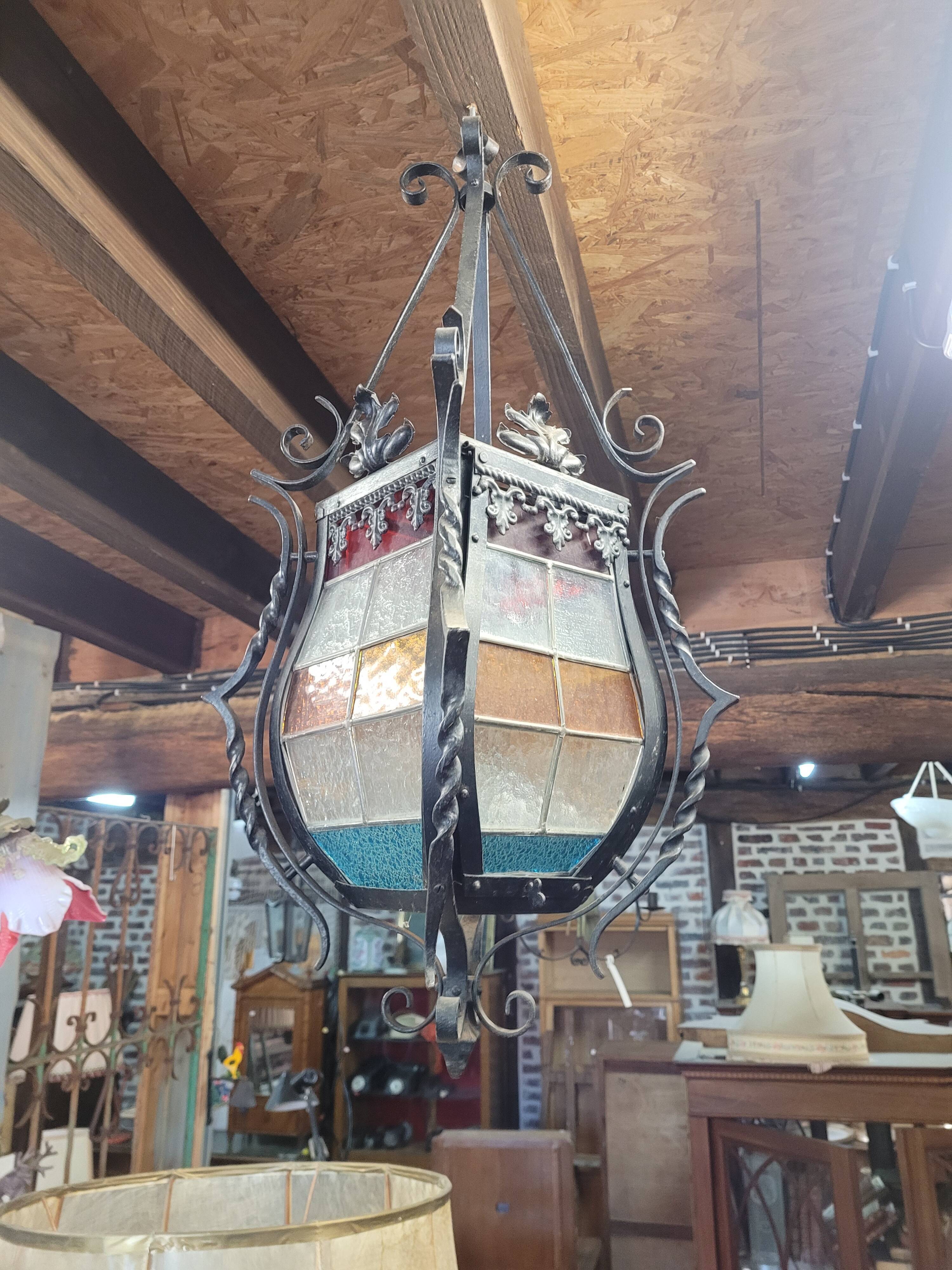 Wrought iron lantern with stained glass windows