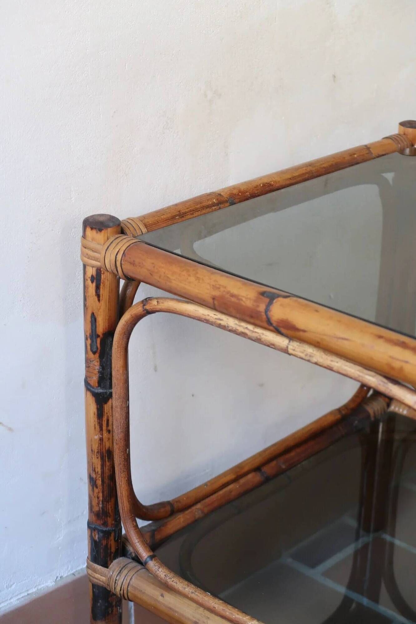Pair of bamboo and rattan bedside tables, smoked glass tops.